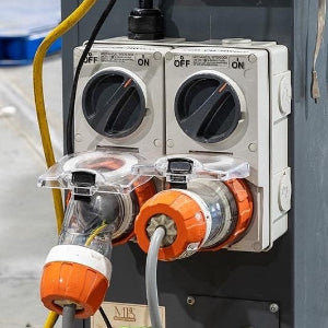 Electrical panel with connectors and wiring on a concrete floor